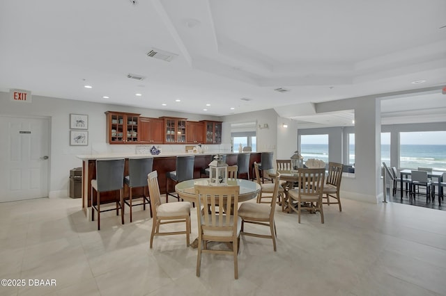 dining room with visible vents, recessed lighting, baseboards, and a tray ceiling