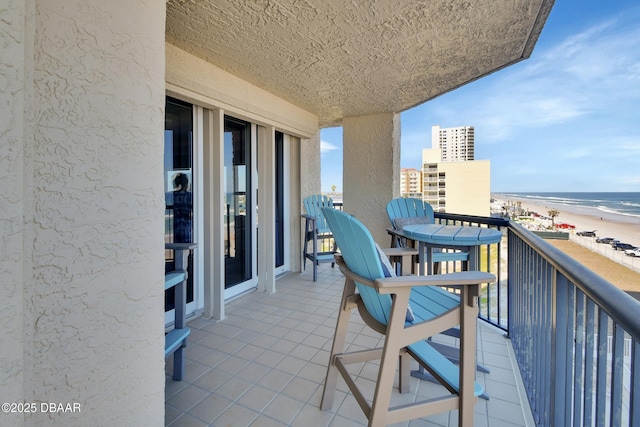 balcony with a view of the beach and a water view