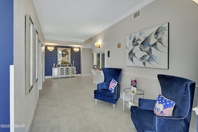 sitting room featuring visible vents, baseboards, ornamental molding, and tile patterned flooring