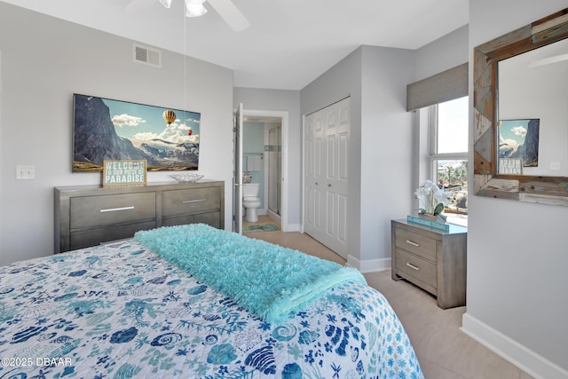 bedroom featuring visible vents, ceiling fan, ensuite bathroom, and baseboards