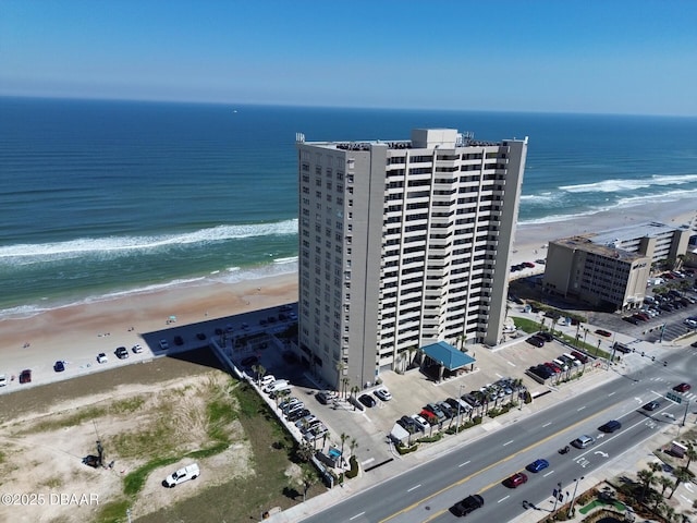 drone / aerial view featuring a view of the beach and a water view