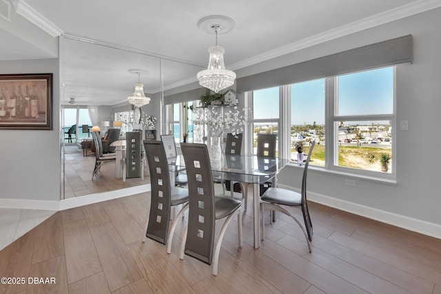 dining area with a wealth of natural light, wood finished floors, a notable chandelier, and ornamental molding