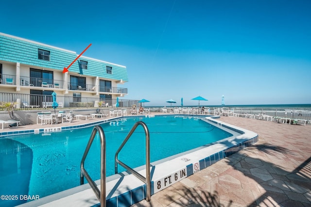 view of swimming pool with a water view