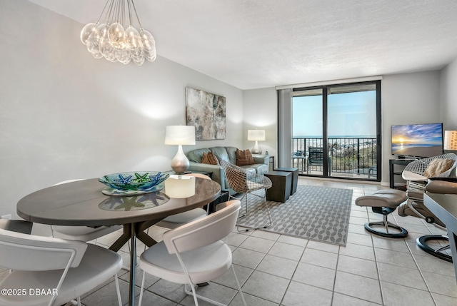 living area featuring a chandelier, expansive windows, and light tile patterned floors