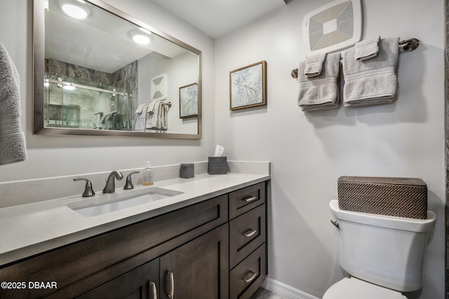 full bathroom with toilet, a shower stall, and vanity