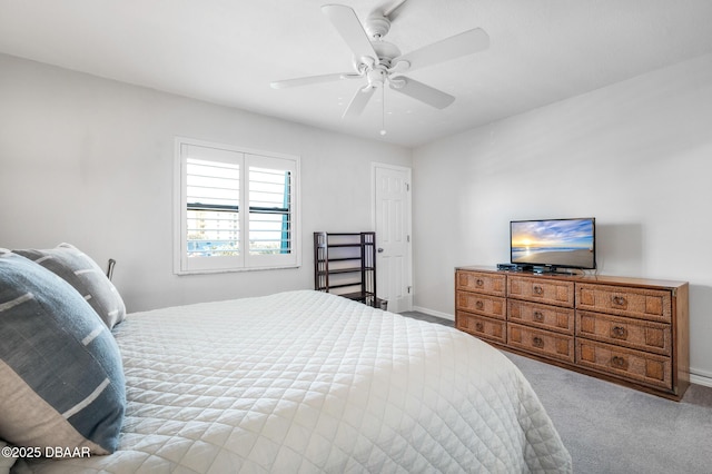 carpeted bedroom with ceiling fan and baseboards