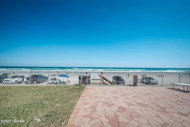 view of patio / terrace featuring a water view and a view of the beach