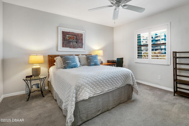 bedroom with a ceiling fan, carpet flooring, and baseboards