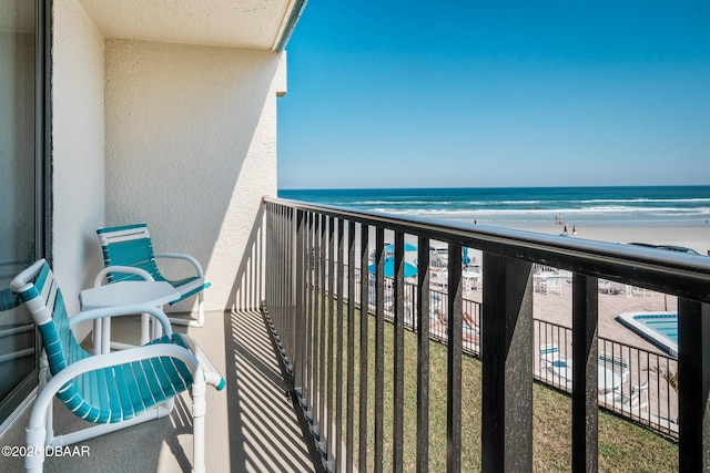 balcony with a view of the beach and a water view