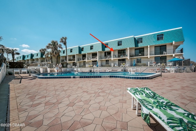 pool featuring a patio area and fence