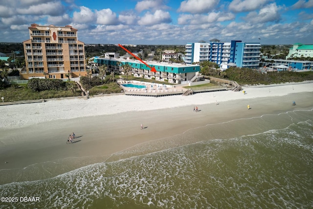 bird's eye view featuring a view of the beach, a water view, and a view of city