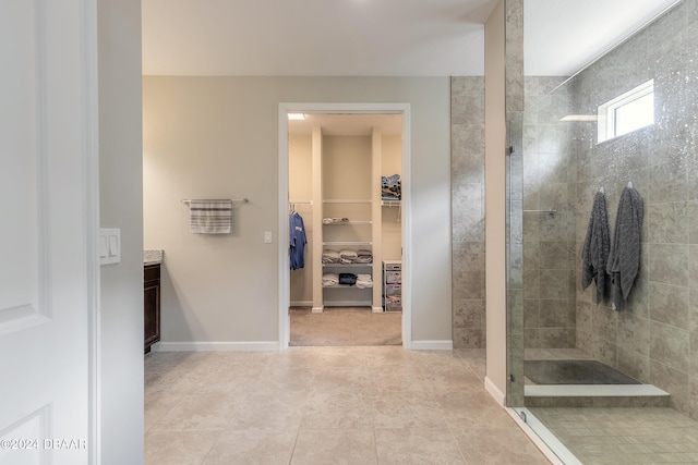 bathroom with vanity, tile patterned floors, and a tile shower