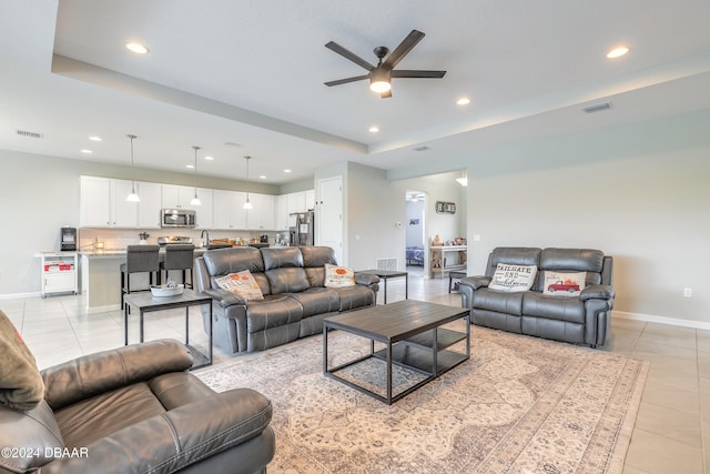 tiled living room with ceiling fan