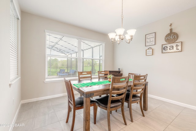 tiled dining room with a notable chandelier