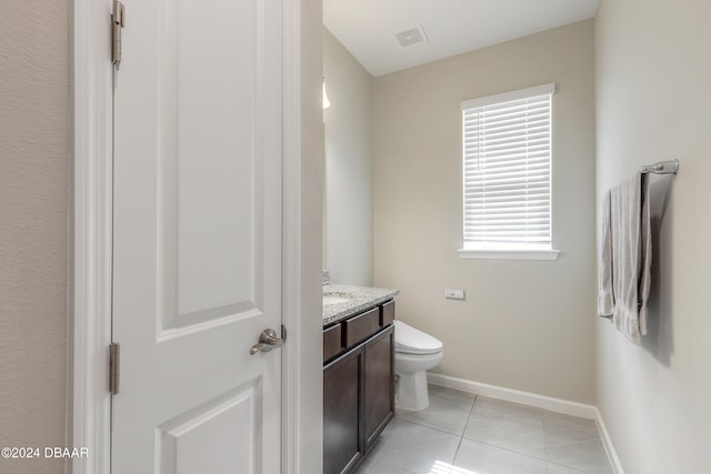 bathroom with vanity, tile patterned floors, and toilet