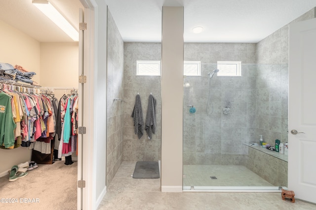 bathroom featuring tile patterned floors and a tile shower