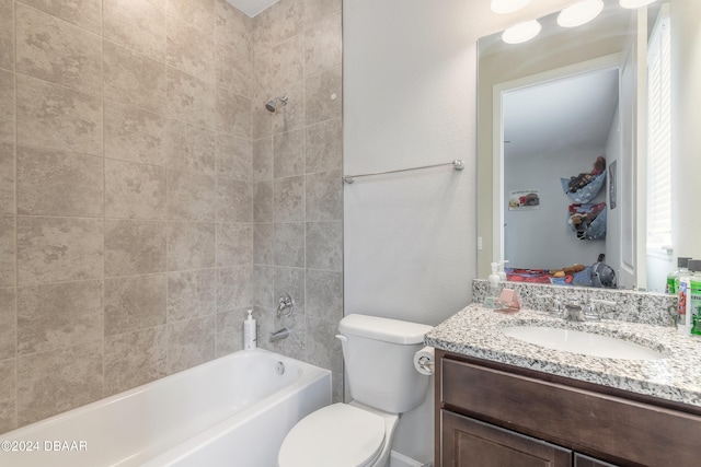 full bathroom with toilet, tiled shower / bath combo, and vanity