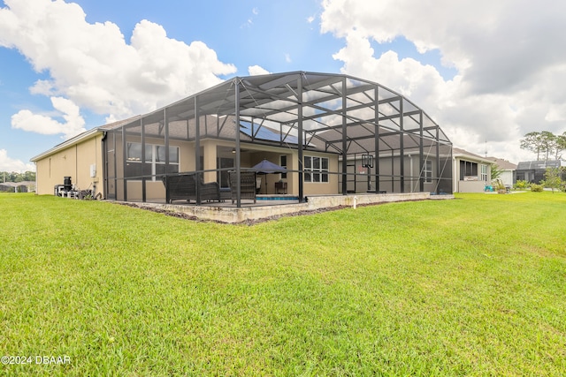 back of house with glass enclosure, a yard, and a patio area