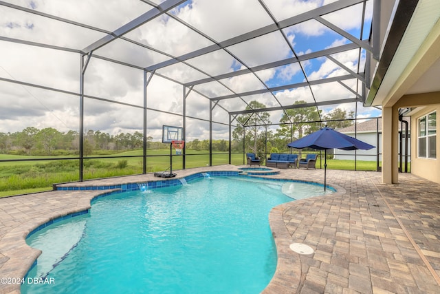 view of pool featuring glass enclosure, an in ground hot tub, and a patio area