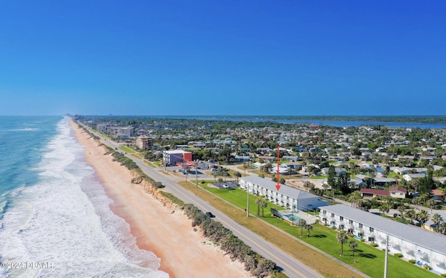 birds eye view of property featuring a water view and a beach view