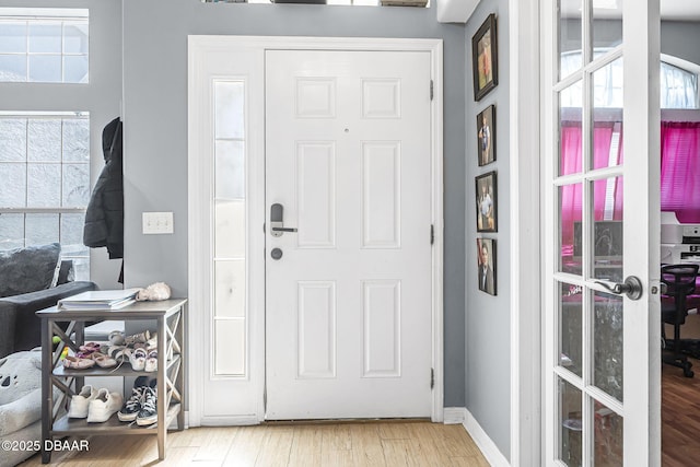 foyer entrance featuring french doors and light hardwood / wood-style floors