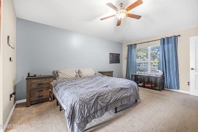 bedroom with vaulted ceiling, light colored carpet, and ceiling fan