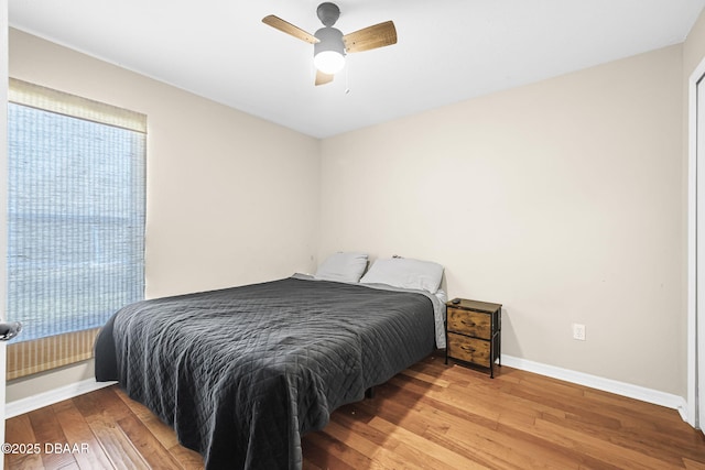 bedroom with ceiling fan and light hardwood / wood-style floors