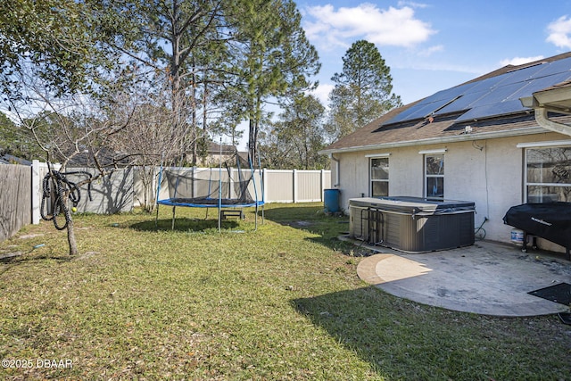 view of yard with a hot tub, central AC, a trampoline, and a patio area