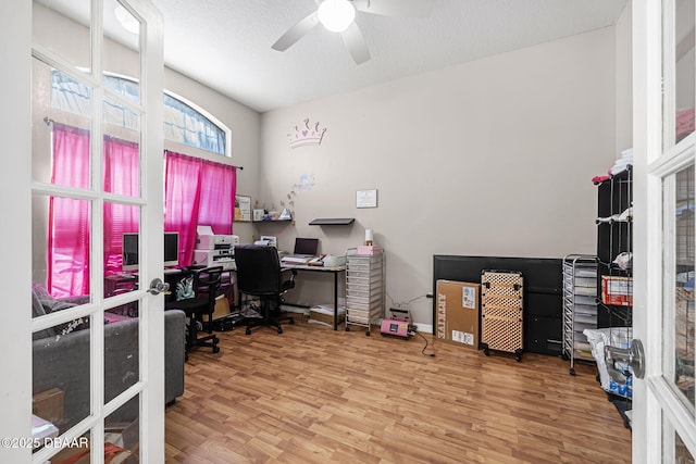 home office featuring hardwood / wood-style floors, a textured ceiling, and ceiling fan