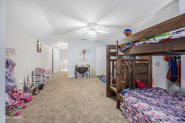 carpeted bedroom featuring vaulted ceiling, a closet, and ceiling fan