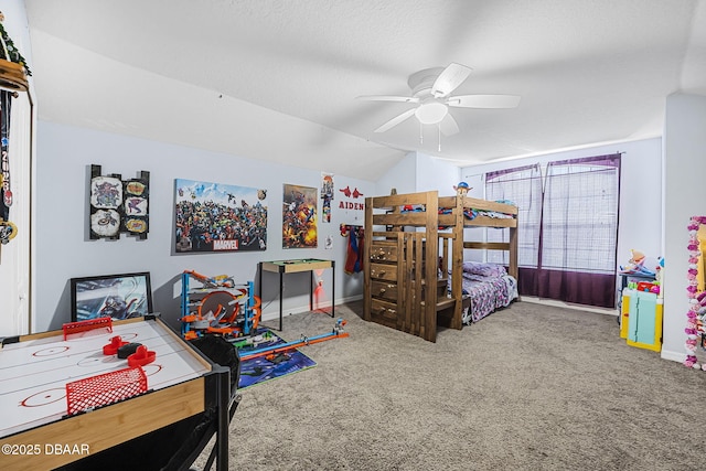 bedroom with ceiling fan, lofted ceiling, carpet flooring, and a textured ceiling