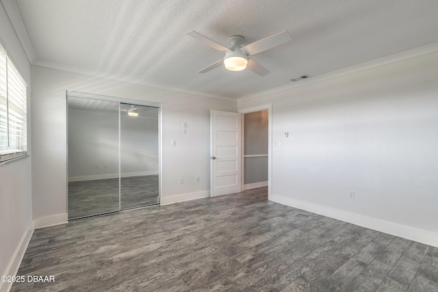 325 N Causeway Cswy Unit C401, New Smyrna Beach, FL 32169 - unfurnished bedroom with a closet, ornamental molding, a textured ceiling, and wood finished floors