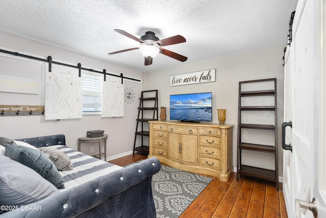 840 River Oak Dr W, Ormond Beach, FL 32174 - living room with a barn door, ceiling fan, a textured ceiling, and wood finished floors