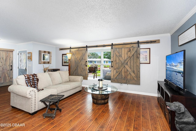 840 River Oak Dr W, Ormond Beach, FL 32174 - living room featuring a barn door, a textured ceiling, ornamental molding, and wood finished floors