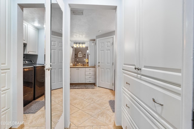 840 River Oak Dr W, Ormond Beach, FL 32174 - corridor with washing machine and dryer and light tile patterned floors