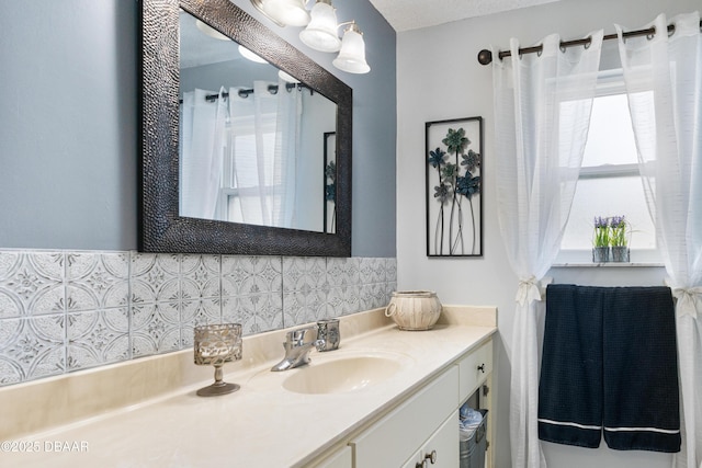 840 River Oak Dr W, Ormond Beach, FL 32174 - bathroom featuring vanity, plenty of natural light, and tasteful backsplash