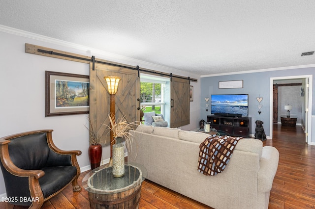840 River Oak Dr W, Ormond Beach, FL 32174 - living room with a barn door, a textured ceiling, crown molding, and wood finished floors