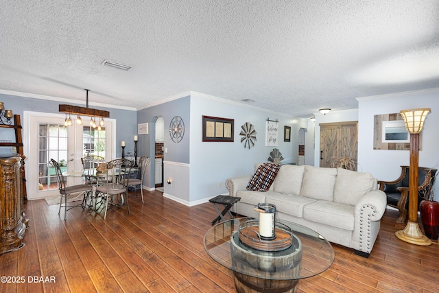840 River Oak Dr W, Ormond Beach, FL 32174 - living area featuring a textured ceiling, wood finished floors, crown molding, and french doors