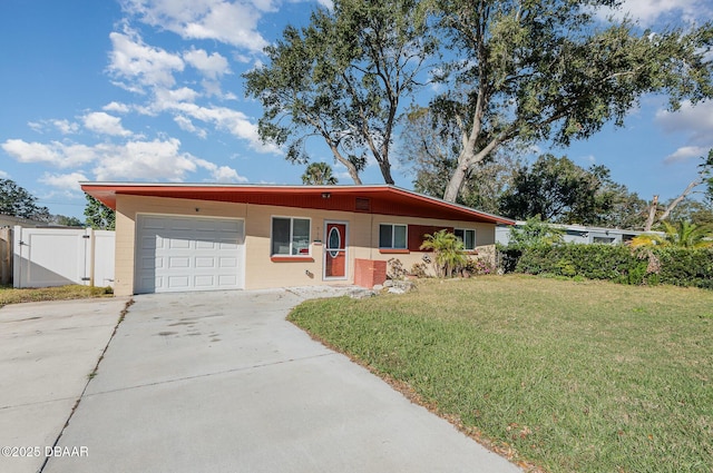 single story home featuring a garage and a front yard