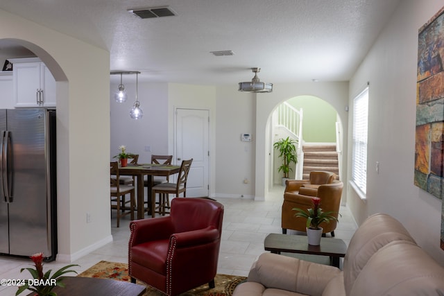 tiled living room with a textured ceiling