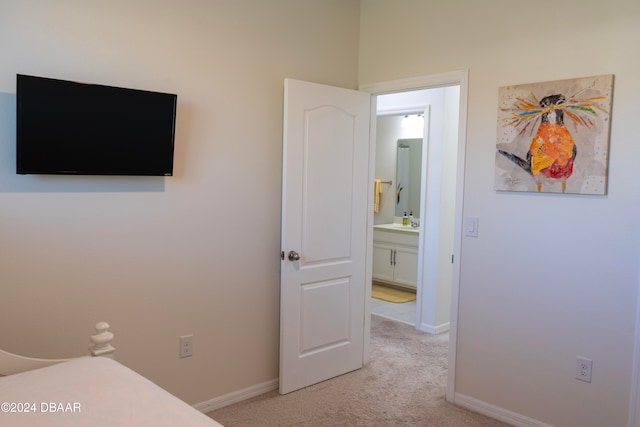 carpeted bedroom featuring connected bathroom