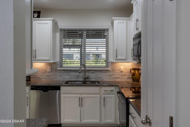 kitchen featuring electric range, sink, stainless steel dishwasher, dark stone countertops, and white cabinets