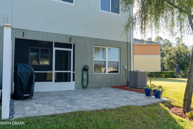 back of house featuring a patio, a yard, and central AC