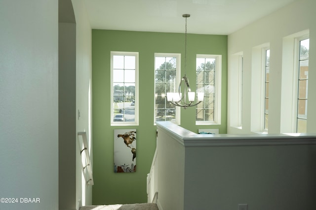 unfurnished sunroom featuring a notable chandelier