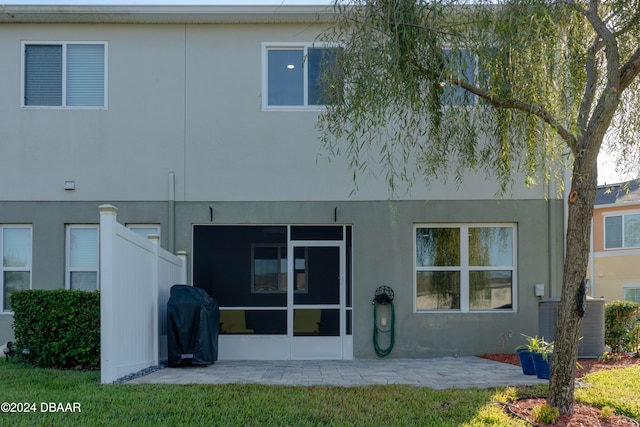 back of property featuring central AC unit