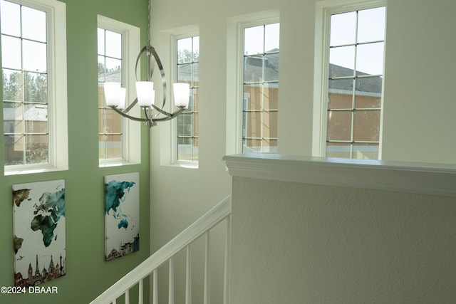 doorway to outside featuring an inviting chandelier