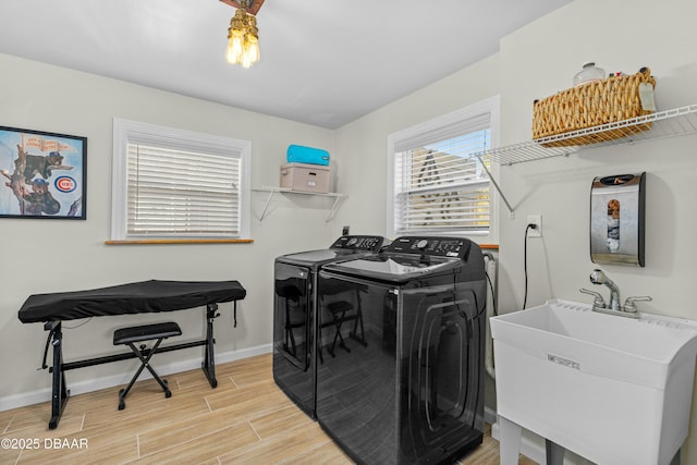 laundry area featuring washer and clothes dryer and sink