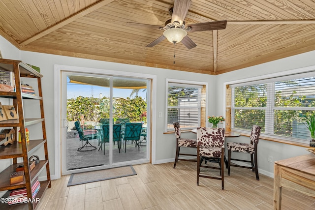 sunroom / solarium with a healthy amount of sunlight, ceiling fan, wood ceiling, and lofted ceiling