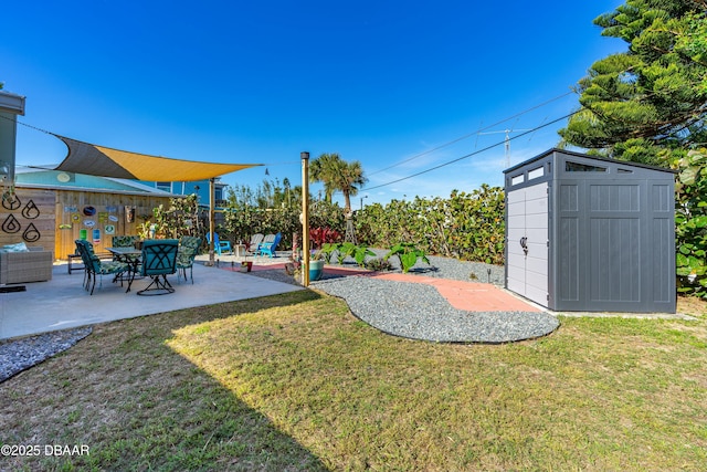 view of yard with a storage shed and a patio