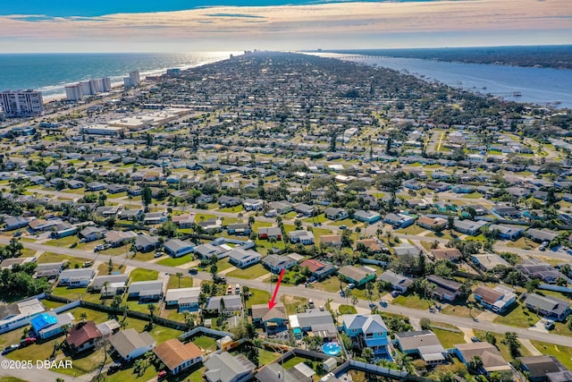 drone / aerial view featuring a beach view and a water view